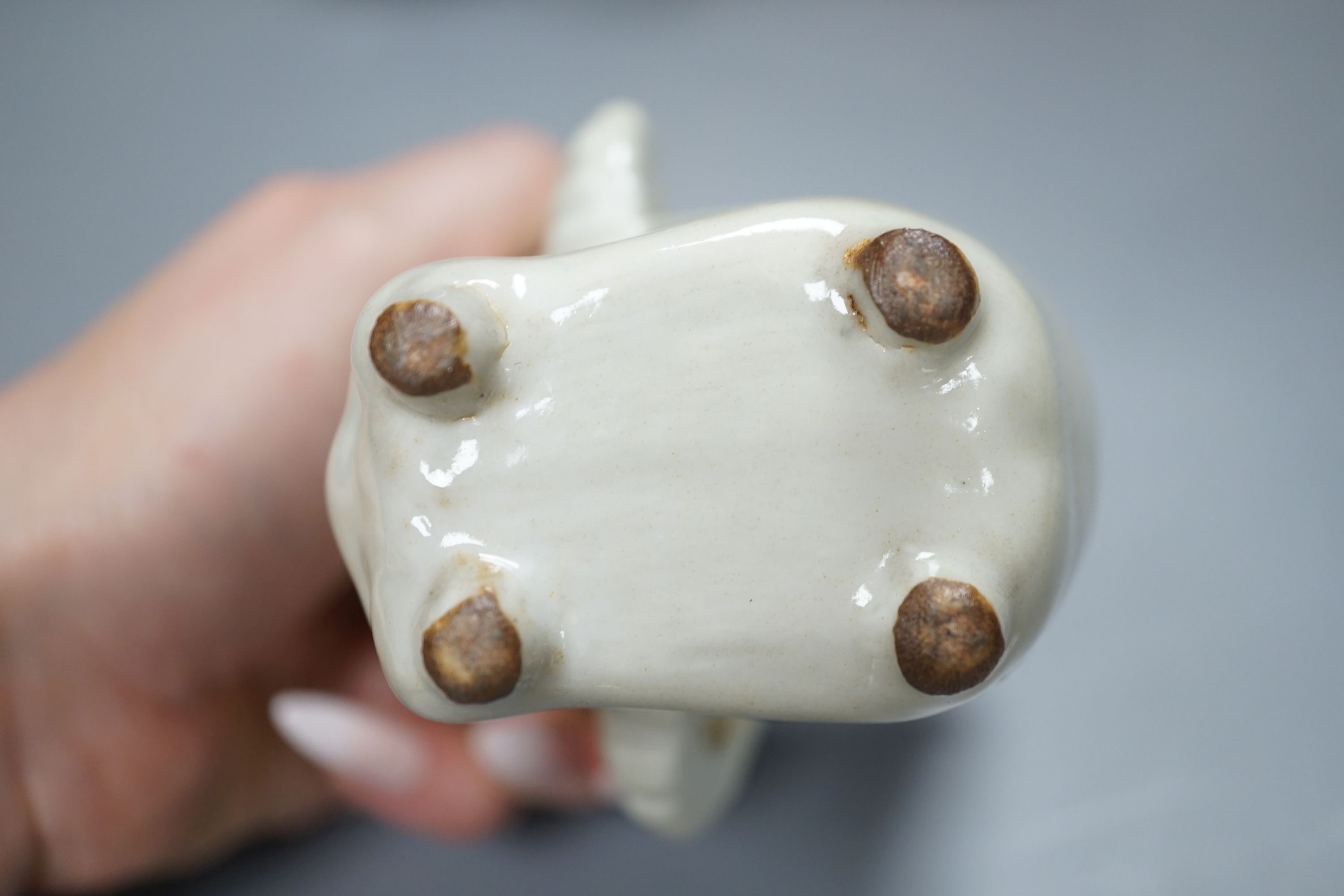 A Chinese blanc de chin figure of a lady with a bird, 37cm, together with a famille rose teapot, a yixing style teapot, blue and white jar and cover and a pale celadon ground ‘ox head’ libation cup